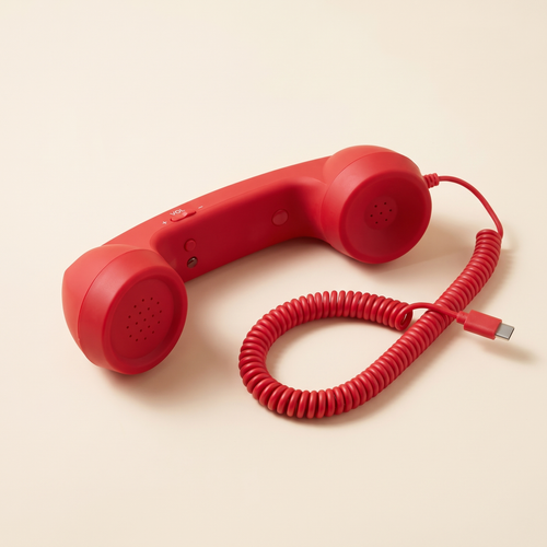 Talkie handset in Cherry, three-quarter view showing the answer button, volume rocker and coiled USB-C cord.