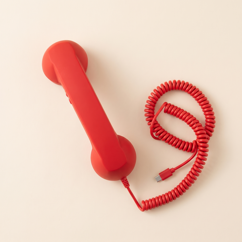 Talkie handset in Cherry, overhead, with coiled cord and USB-C plug.