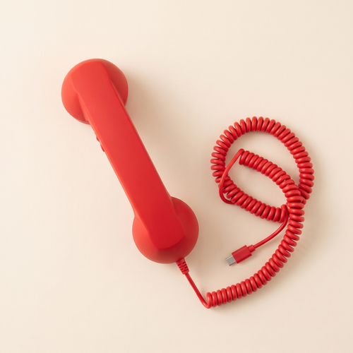 Talkie handset in Cherry, overhead, with coiled cord and USB-C plug.